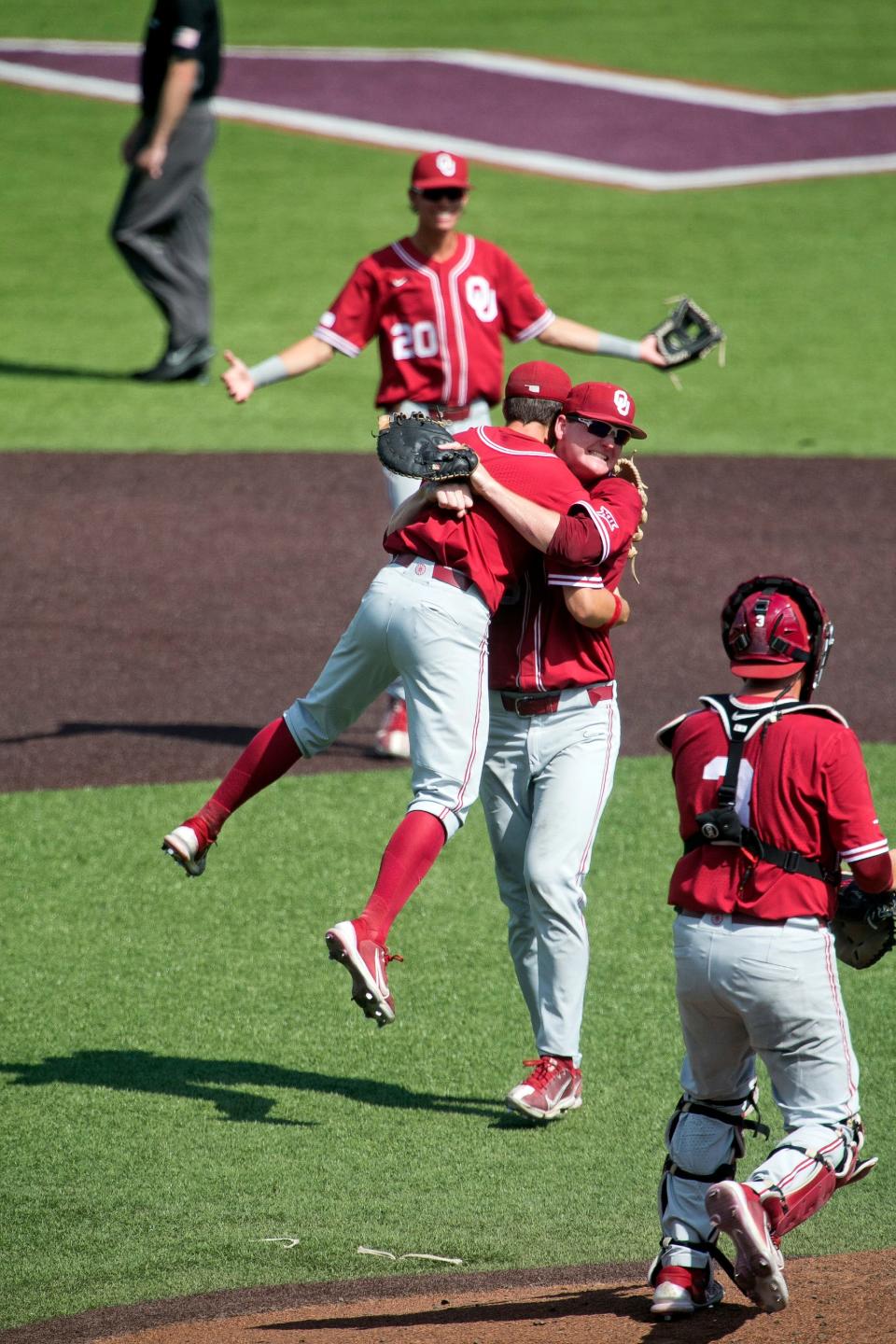 Shortstop Peyton Graham (20) watches his OU teammates celebrate after getting the final out of an 11-2 win at Virginia Tech in Game 3 of the Blacksburg Super Regional on Sunday.