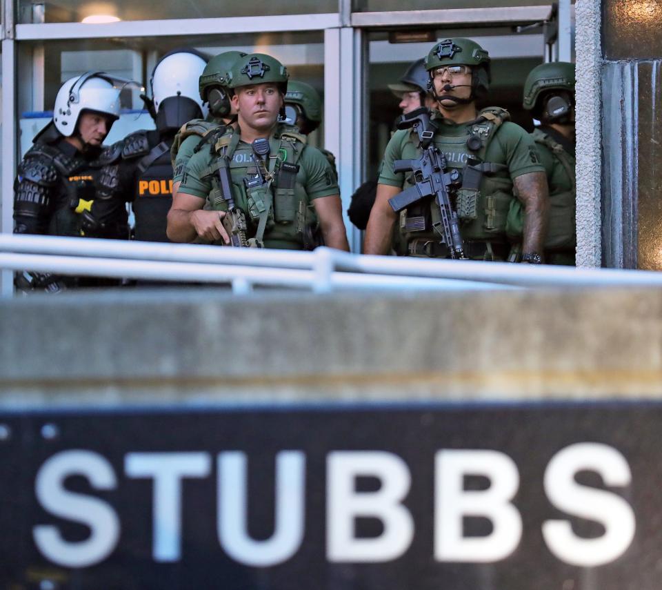 The Akron SWAT team stands on the front step of the Harold K. Stubbs Justice Center on Monday.