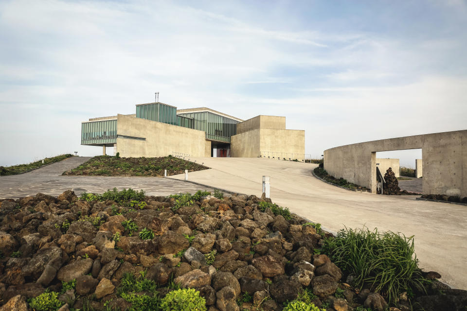 The scenic view of Glass House designed by famous architect Tadao Ando, Seobjikoji on Jeju Island, South Korea. Constructed mostly of exposed concrete, glass, and steel, the building overlooks toward famous Seongsan-ilchul-bong, a small island nearby.