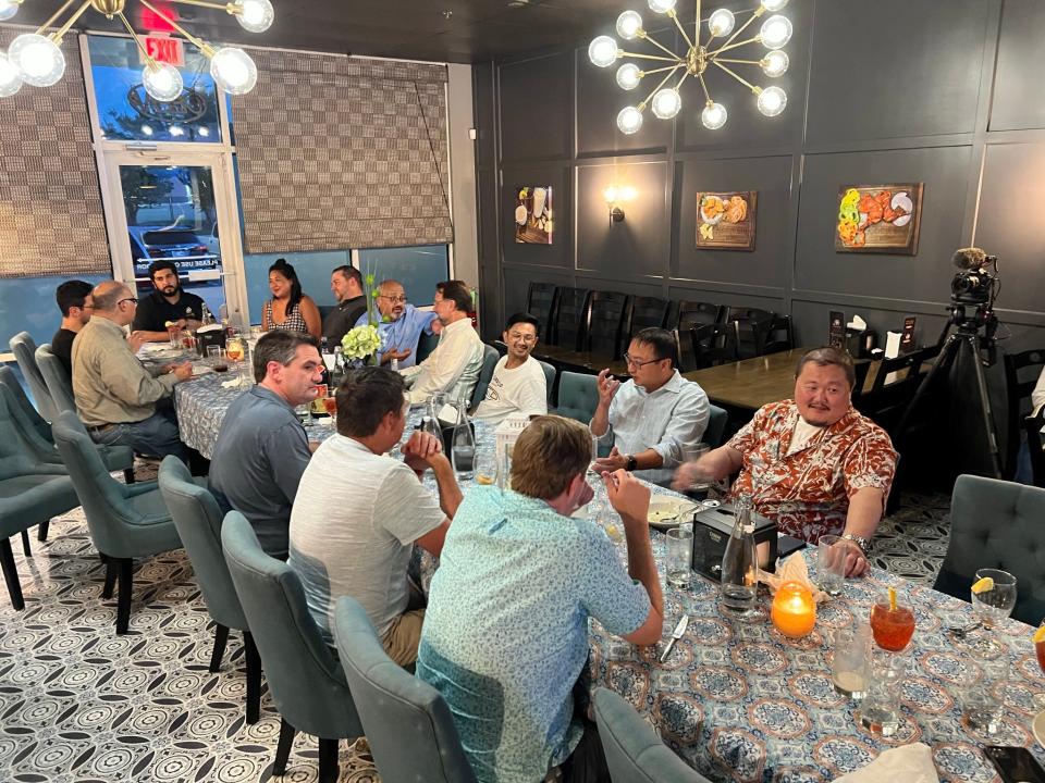 A private group gathers at Kebabish Bites in Norman for a special dinner prepared by chef Waseem Ahmed, seated at the head of the table.