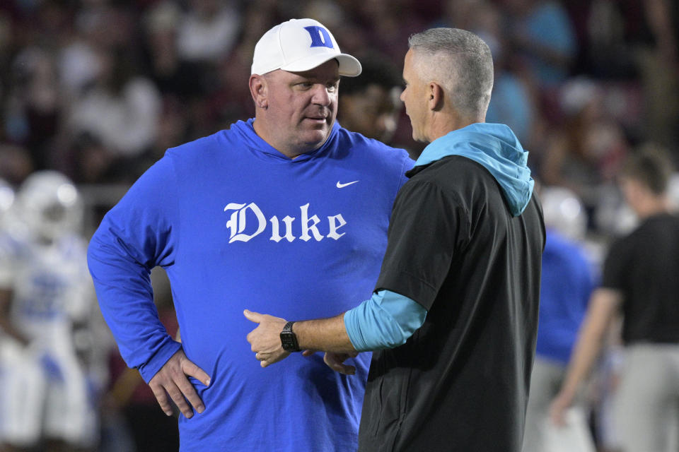 Duke head coach Mike Elko, left, and Florida State head coach Mike Norvell chat on the field before an NCAA college football, Saturday, Oct. 21, 2023, in Tallahassee, Fla. (AP Photo/Phelan M. Ebenhack)