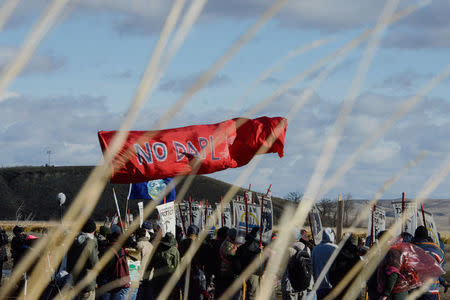 A banner is flown over protesters during a protest against plans to pass the Dakota Access pipeline near the Standing Rock Indian Reservation, near Cannon Ball, North Dakota, U.S. November 18, 2016. REUTERS/Stephanie Keith