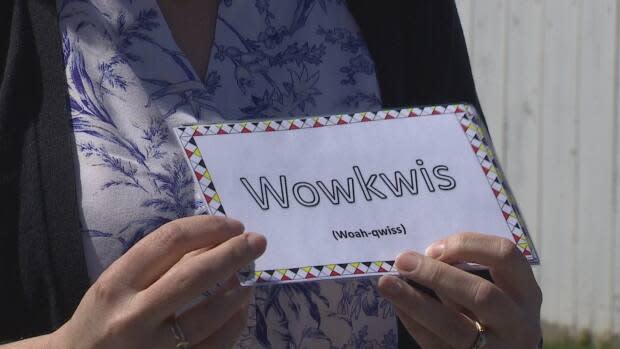 Katie Martin holds one of the Mi'kmaw flash cards created for the language and drumming program by the UPEI students.  