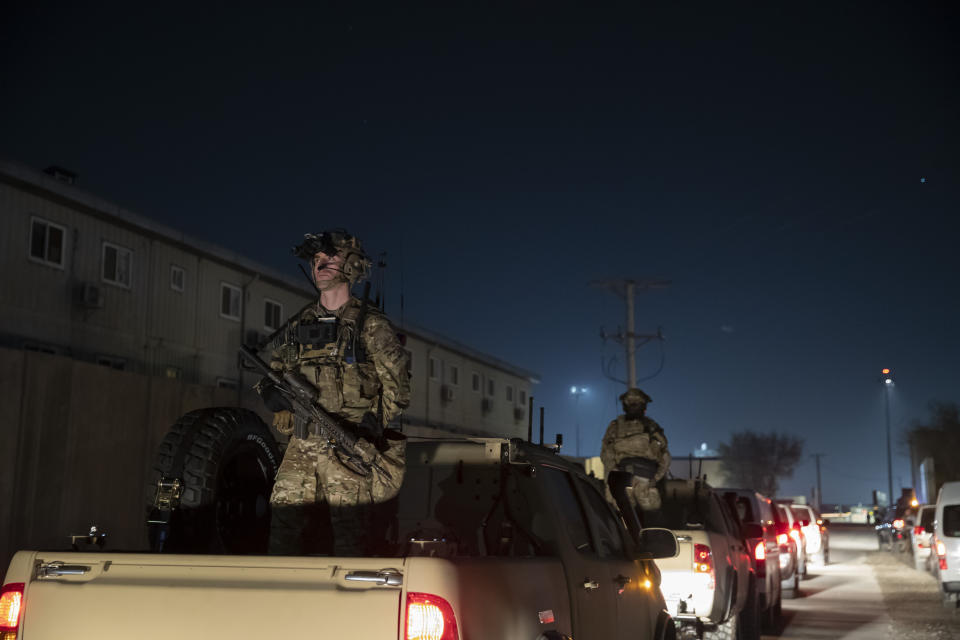 FILE - In this Nov. 28, 2019, file photo armed soldiers stand guard in the motorcade for President Donald Trump speaks during a surprise Thanksgiving Day visit to the troops at Bagram Air Field, Afghanistan. During his election campaign four years ago, Trump vowed to bring all troops home from “endless wars." In recent months he's only increased the pressure, working to fulfill his campaign promise and get forces home before Election Day. (AP Photo/Alex Brandon, File)