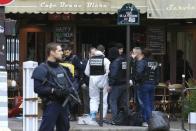 Police investigators work at the scene of a shooting in a bar in Rue de le Fontaine the morning after a series of deadly attacks in Paris , November 14, 2015. REUTERS/Pascal Rossignol