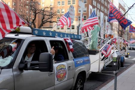 Rob Cortis of Detroit, Michigan drives his modified Trump Unity Bridge trailer through downtown Washington January 19, 2017. REUTERS/James Lawler Duggan