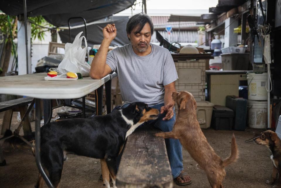 Mark Apuron, who says he was raped by his uncle, Archbishop Anthony Apuron when he was 15, sits in the backyard of the home he's now staying at in Dededo, Guam, Monday May 13, 2019. He never found the right words to tell his parents what happened. "I didn't think I would be believed," he said, tearing up. "I thought I was the only one." Over time, Mark Apuron and his parents drifted apart _ a rift he says began the day his father's brother raped him. Anthony Apuron denies the allegations, which are detailed in a lawsuit. (AP Photo/David Goldman)