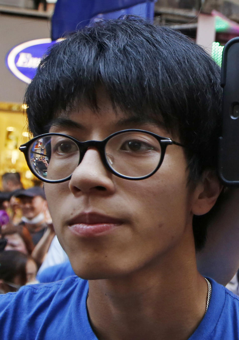 In this Saturday, July 11, 2015 photo, Ray Wong Toi-yeung, member of Hong Kong Indigenous group attends a demonstration in Hong Kong. Germany has granted asylum to two Hong Kong activists in a sign of growing concern over how dissent is dealt with in the territory. (AP Photo/Kin Cheung)