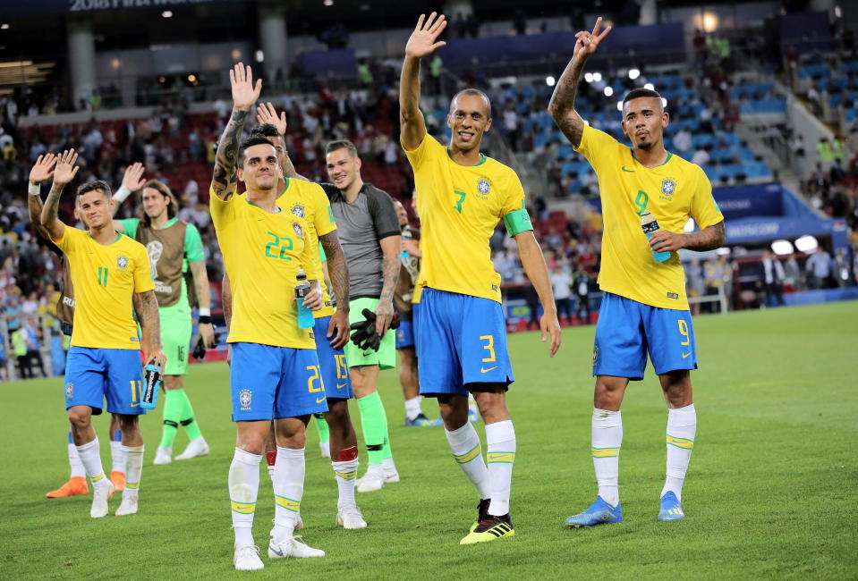 Brazil players salute their fans after securing their passage through to the last 16