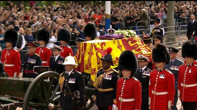 Crowds gathered to watch the procession from Buckingham Palace to the Palace of Westminster, where Queen Elizabeth II will lie in state in Westminster Hall. / Credit: BBC Events