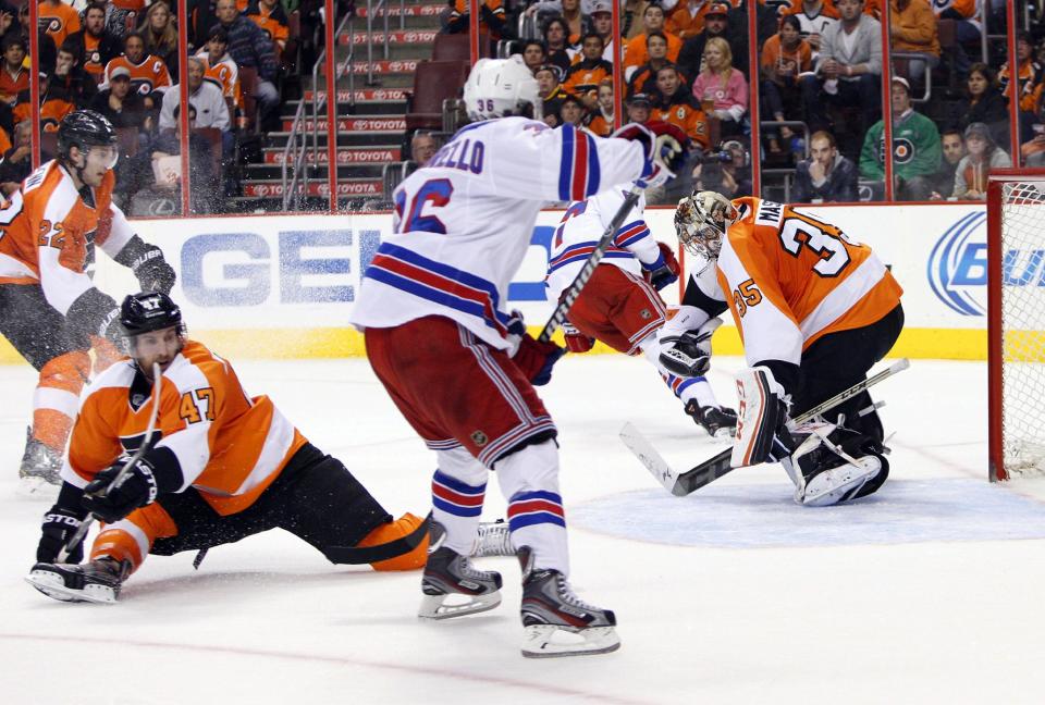 Philadelphia Flyers' Steve Mason, right, makes a glove save during the second period in Game 6 of an NHL hockey first-round playoff series against the New York Rangers, Tuesday, April 29, 2014, in Philadelphia. (AP Photo/Chris Szagola)