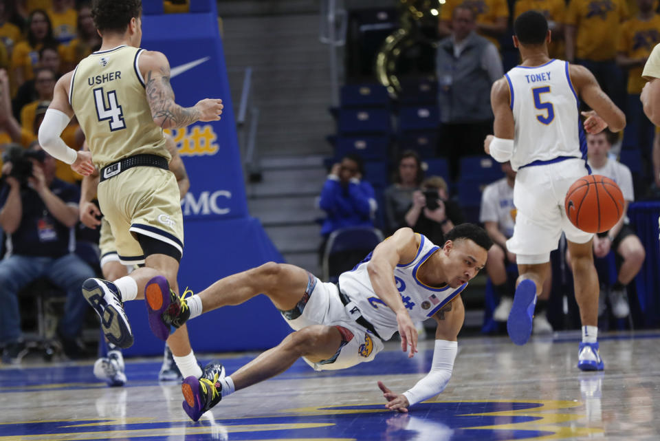 Pittsburgh's Trey McGowens (2) dives for the ball past Georgia Tech's Jordan Usher (4) during the first half of an NCAA college basketball game, Saturday, Feb. 8, 2020, in Pittsburgh. (AP Photo/Keith Srakocic)