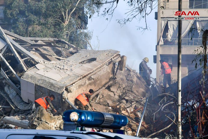 Emergency and security personnel inspect the rubble at the site of strikes that hit a building annexed to the Iranian embassy in Syria's capital Damascus on Monday. Photo by Syrian Arab News Agency/UPI