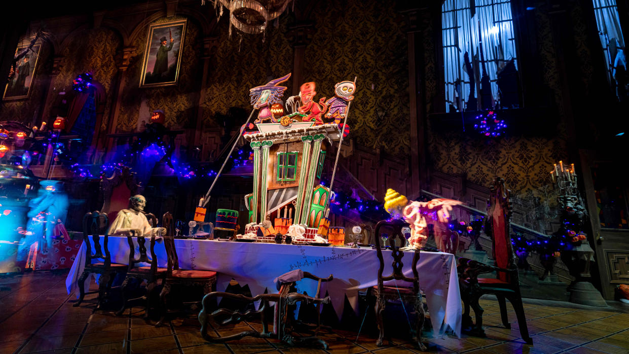 In this handout photo provided by Disney Resorts, a gingerbread house is displayed on the ballroom table inside the Haunted Mansion at Disneyland Park on September 02, 2022 in Anaheim, California.