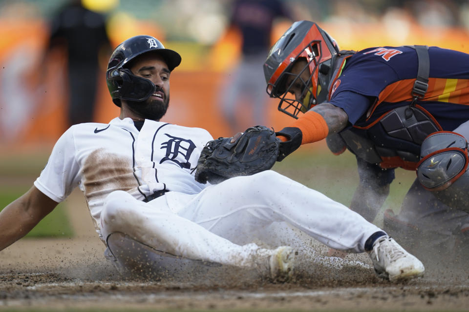 Houston Astros catcher Martin Maldonado, right, tags Detroit Tigers center fielder Riley Greene out at home plate in the first inning of a baseball game in Detroit, Monday, Sept. 12, 2022. (AP Photo/Paul Sancya)