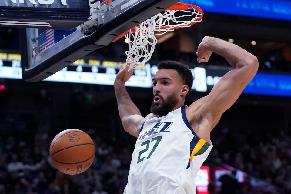 Utah Jazz center Rudy Gobert dunks against the Houston Rockets during the second half of an NBA basketball game on Feb. 14, 2022, in Salt Lake City. Gobert has been traded by the Jazz to the Minnesota Timberwolves for a massive package of players and draft picks, a person with knowledge of the blockbuster deal said.