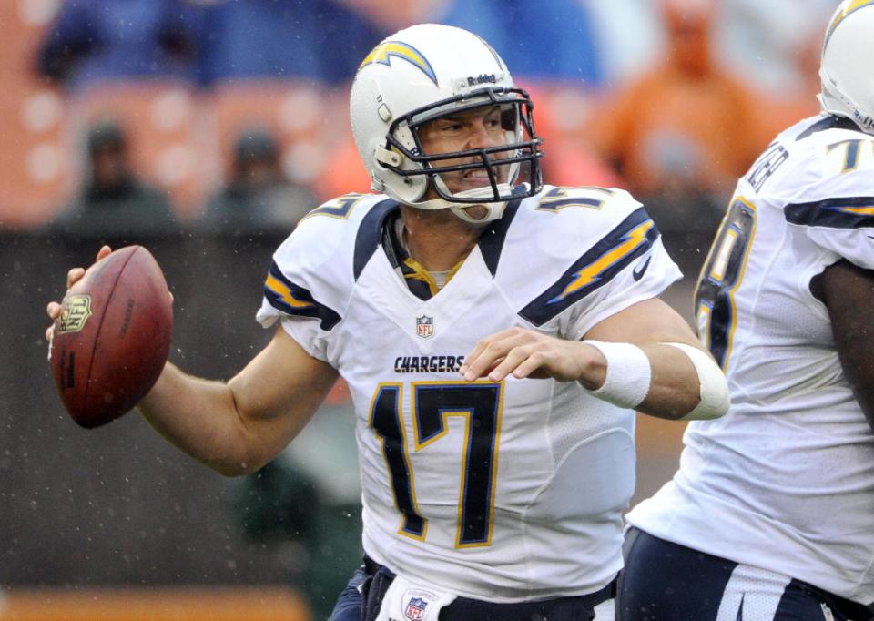 As rain falls, San Diego Chargers quarterback Philip Rivers rolls out to pass in the third quarter of an NFL football game against the Cleveland Browns, Sunday, Oct. 28, 2012, in Cleveland. (AP Photo/Phil Long)