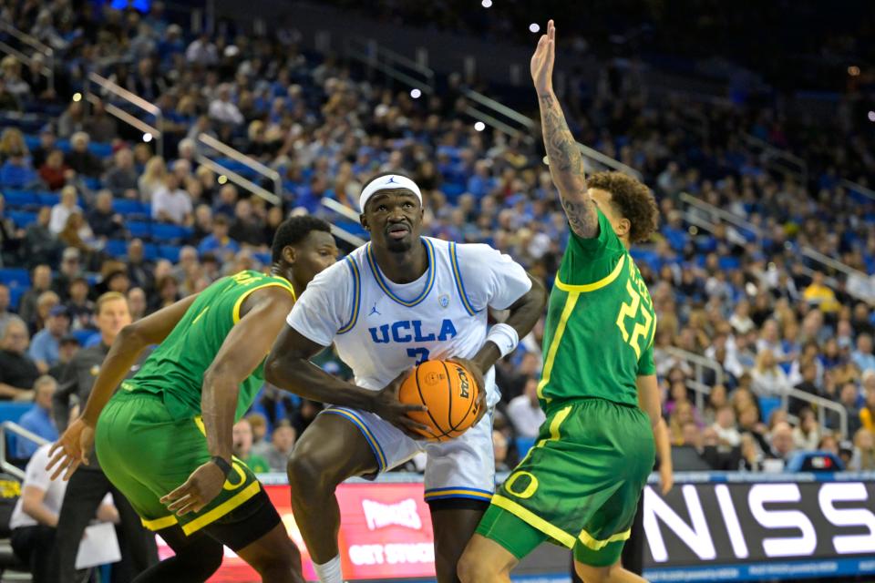 UCLA Bruins forward Adem Bona (3) drives past Oregon Ducks center N'Faly Dante (1) and guard Jadrian Tracey (22) in the first half at Pauley Pavilion Feb. 3, 2024, in Los Angeles.