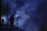 <p>A firefighter surveys a building destroyed by a wildfire Thursday, Oct. 12, 2017, near Calistoga, Calif. (Photo: Jae C. Hong/AP) </p>