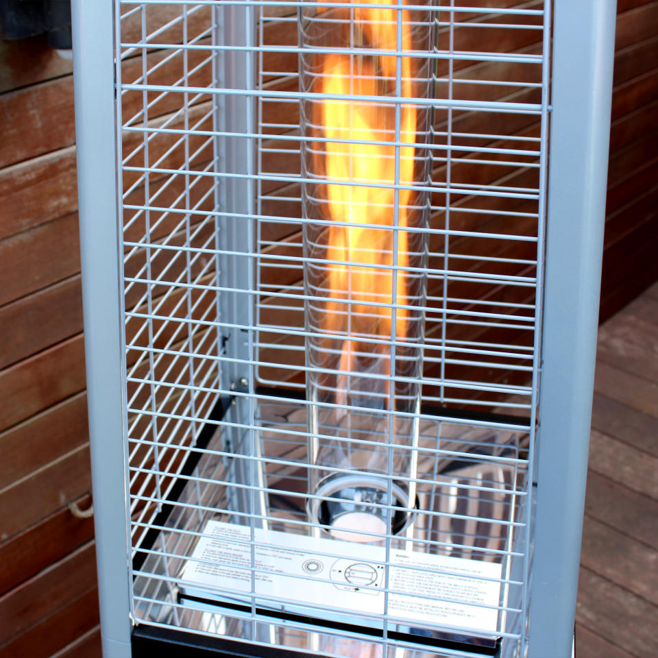 The Outsunny 11.2kw Pyramid Gas Patio Heater being unboxed and tested on a wooden deck