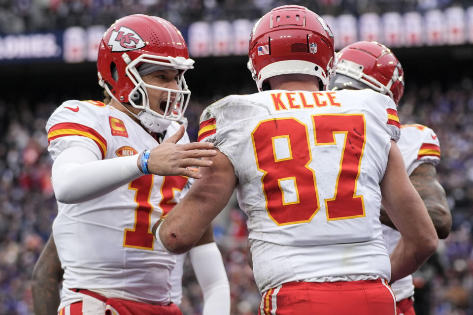 Kansas City Chiefs quarterback Patrick Mahomes (15) celebrates a touchdown catch by tight end Travis Kelce (87) during the first half of an AFC Championship NFL football game against the Baltimore Ravens, Sunday, Jan. 28, 2024, in Baltimore. (AP Photo/Alex Brandon)