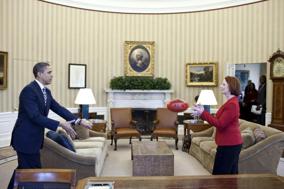 Obama practices passing a football with Australia's then Prime Minister Julia Gillard in the Oval Office. Source: Pete Souza/White House