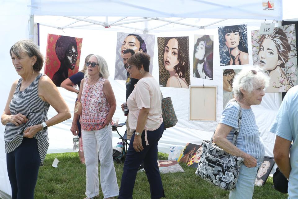 Visitors check out the work of artist Jillian Krenshaw during the annual Wickford Art Festival in 2021.