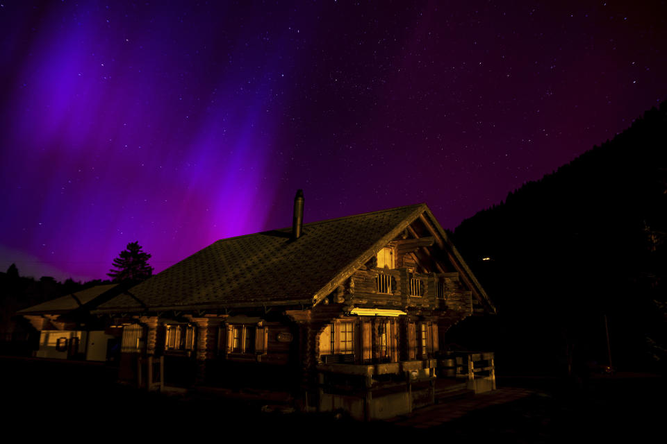 The Northern Lights, or Aurora Borealis, illuminate the night sky over the mountains in Le Col des Mosses pass, Ormont-Dessous, Switzerland, during the early hours of Saturday, May 11, 2024. Brilliant purple, green, yellow and pink hues of the Northern Lights were reported worldwide, with sightings in Germany, Switzerland, London, and the United States and Canada. (Jean-Christophe Bott/Keystone via AP)