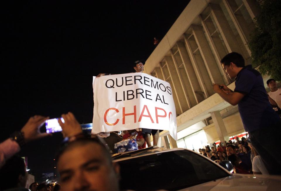 A protester holds a sign reading, "We want Chapo free" during a march in Culiacan