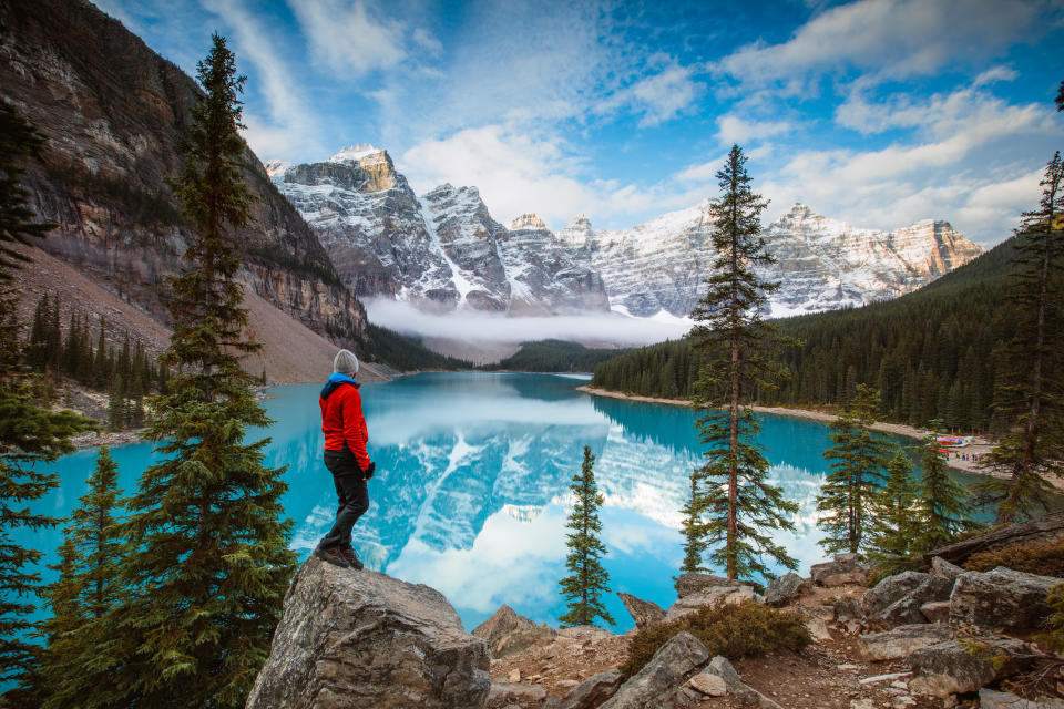 Man looking at Moraine lake at sunrise, Banff National Park, Alberta, Canada (MR)