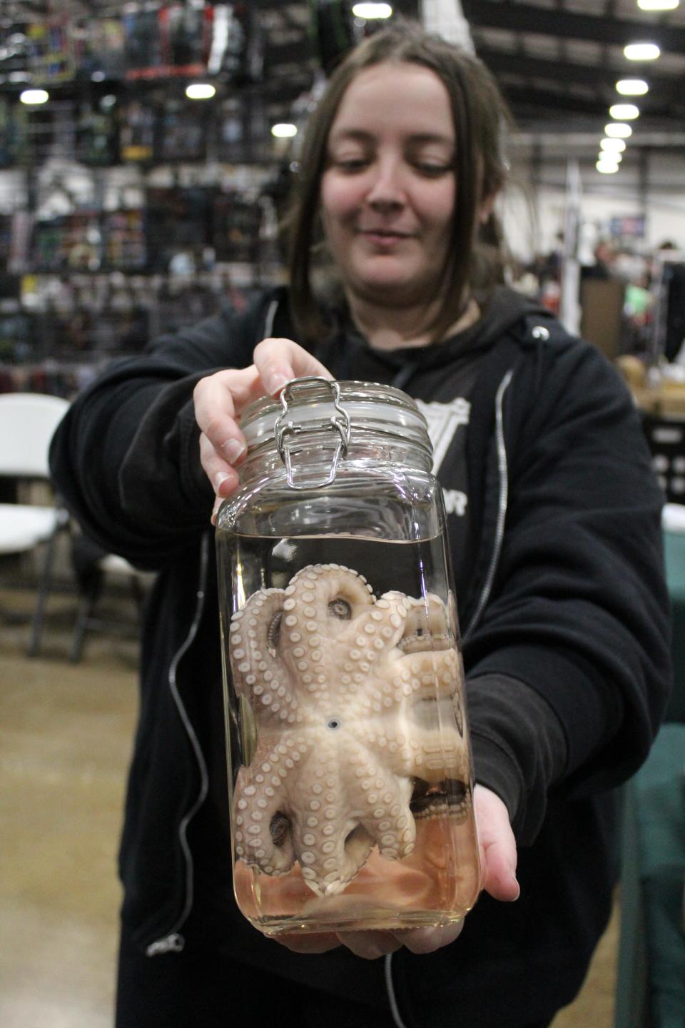 Kristen Ollivander holds one of the wet specimens for sale at Internally Comatose Curiosities and Creations.