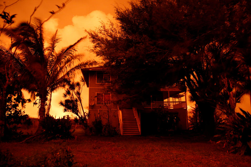 <p>Lava illuminates an evacuated house on the outskirts of Pahoa during ongoing eruptions of the Kilauea Volcano in Hawaii, June 6, 2018. (Photo: Terray Sylvester/Reuters) </p>