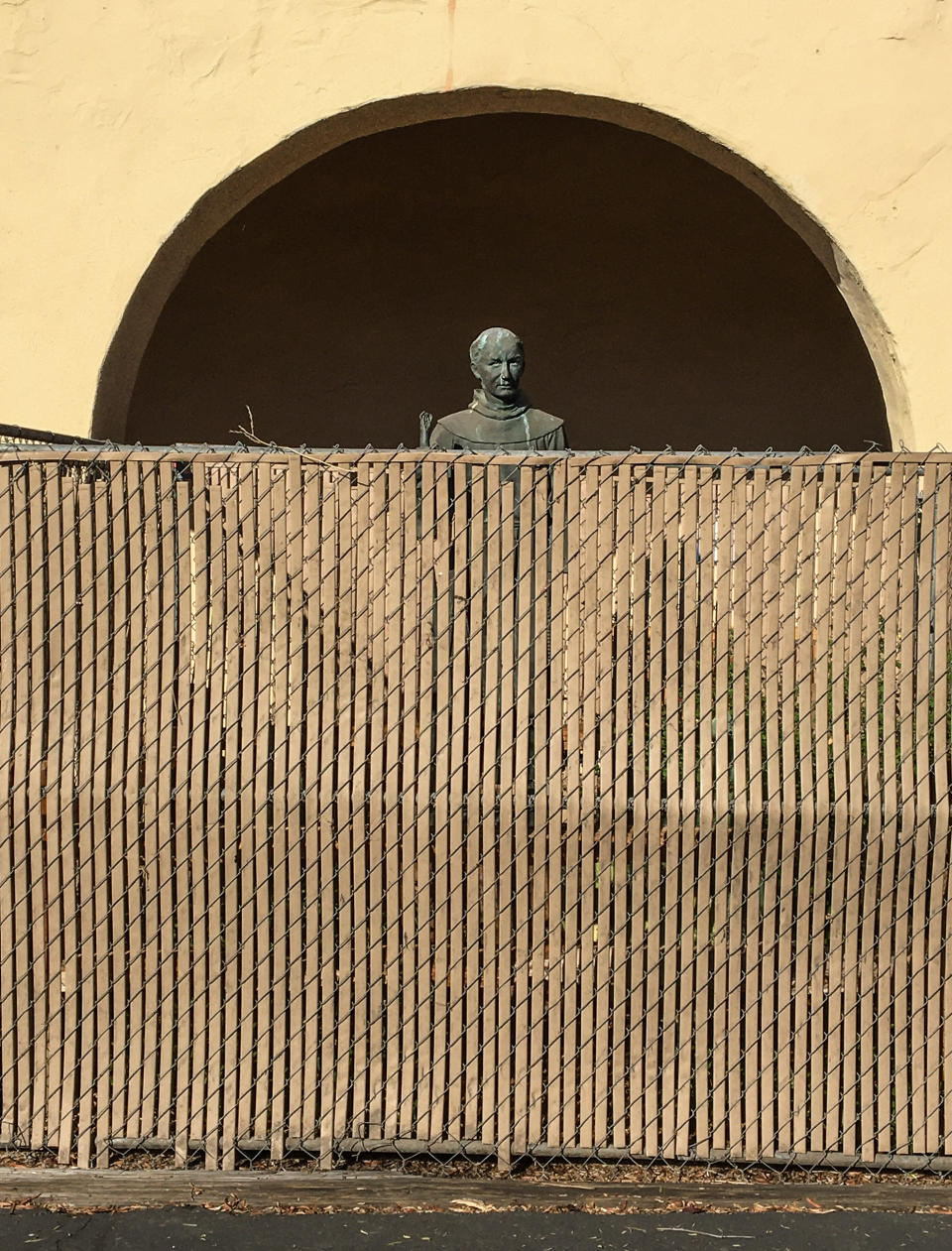 A bronze statue of St. Jun&iacute;pero Serra, located at the entrance to the Old Mission Santa Ines in Solvang, California, is surrounded by a chainlink fence to protect it on Nov. 2, 2020. (Photo: George Rose via Getty Images)