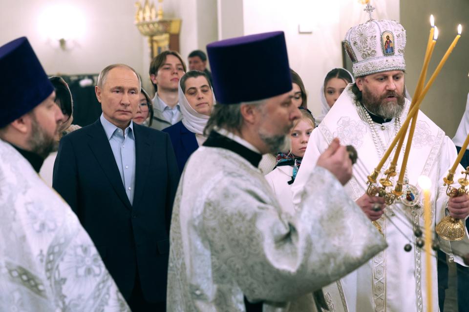 FILE - Russian President Vladimir Putin, second from left, attends an Orthodox Christmas service with families of military personnel at a church near his Novo-Ogaryovo state residence outside Moscow, Russia, on Sunday, Jan. 7, 2024. A series of recent Ukrainian attacks inside Russia have dealt a heavy blow to Putin's attempts to reassure Russians that life in the country has been largely unchanged by the nearly two-year military operation. (Gavriil Grigorov/Sputnik, Kremlin Pool Photo via AP, File)