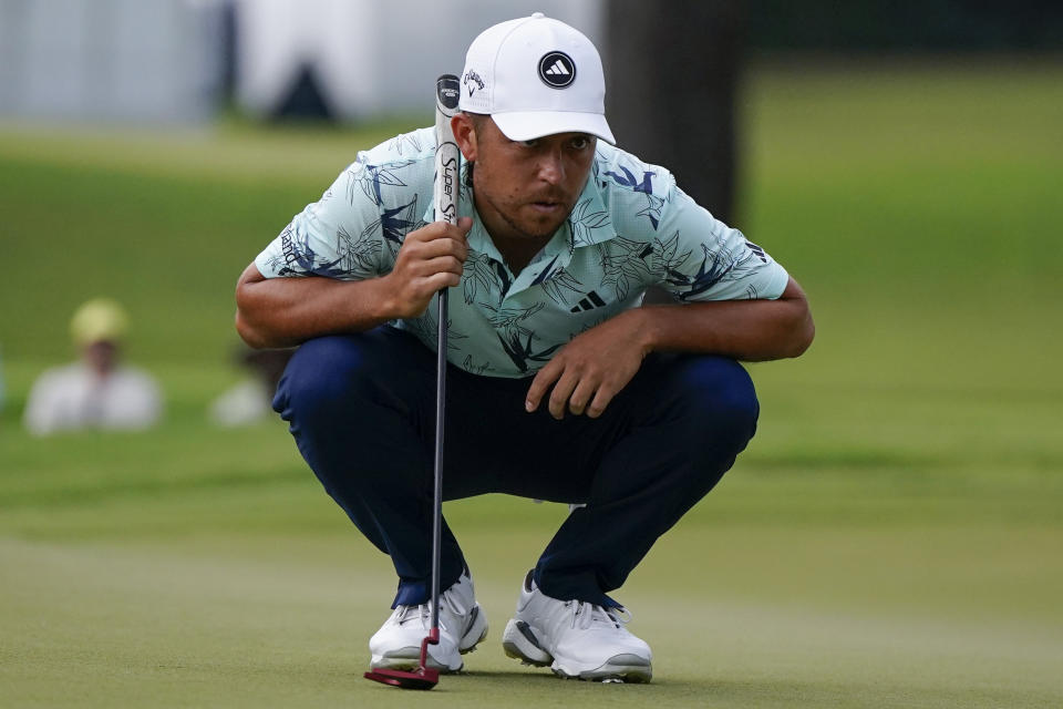 Xander Schauffele lines up a putt on the fifth green during the third round of the Tour Championship golf tournament, Sunday, Aug. 27, 2023, in Atlanta. (AP Photo/Mike Stewart)