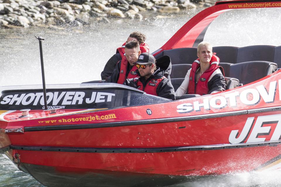 Biebs boards a boat and looks, well bored...