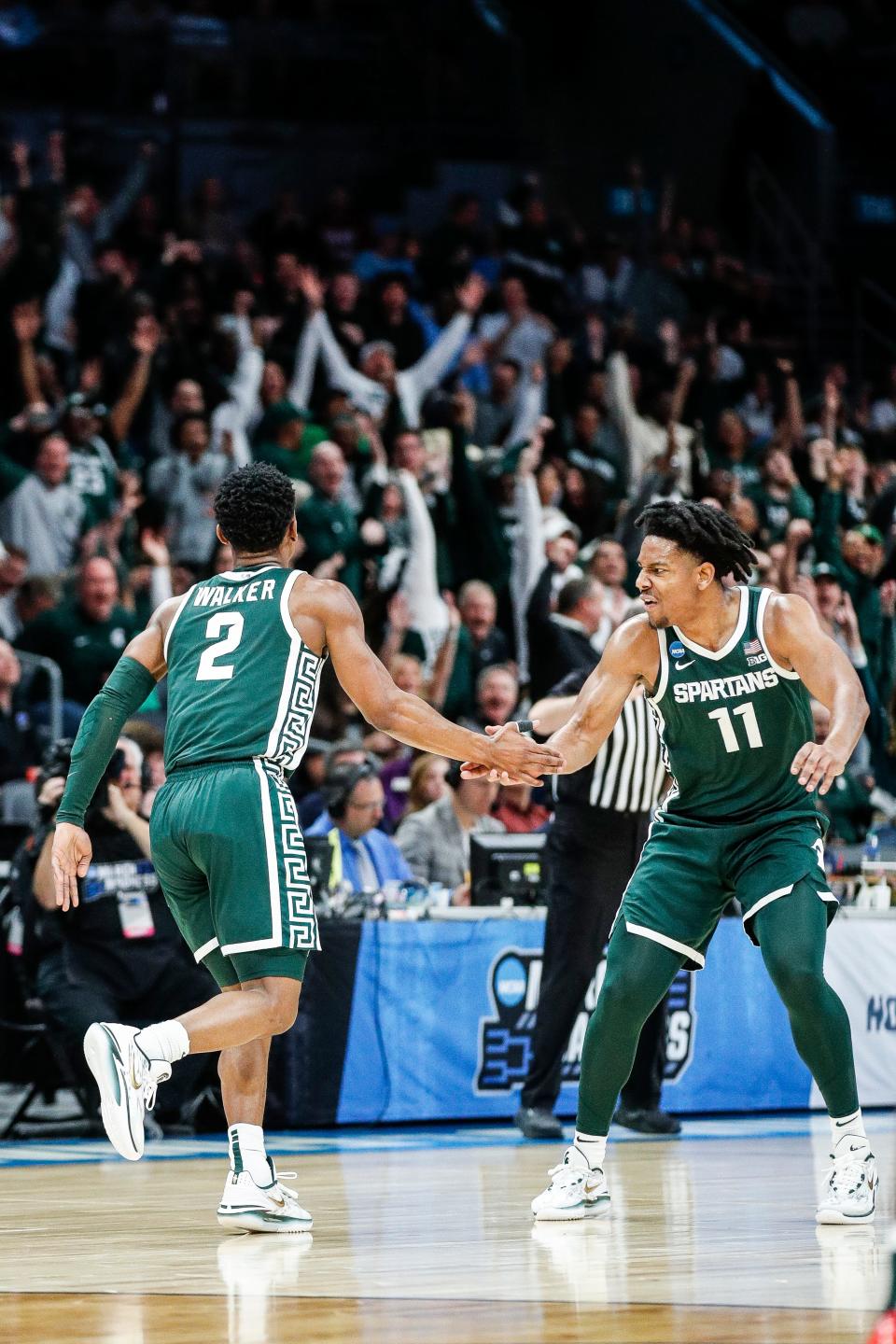 Michigan State guard Tyson Walker (2) celebrates a three point basket with guard A.J. Hoggard (11) during the first half of NCAA tournament West Region first round at Spectrum Center in Charlotte, N.C. on Thursday, March 21, 2024.