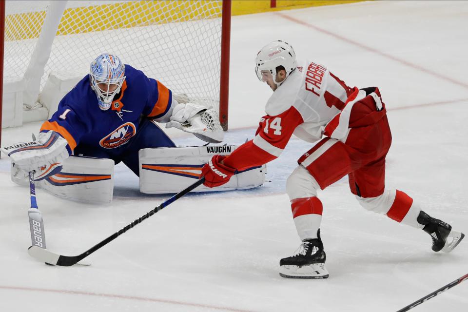 New York Islanders goaltender Thomas Greiss (1) poke checks Detroit Red Wings' Robby Fabbri (14) during the third period of an NHL hockey game Tuesday, Jan. 14, 2020, in Uniondale, N.Y. The Islanders won 8-2. (AP Photo/Frank Franklin II)