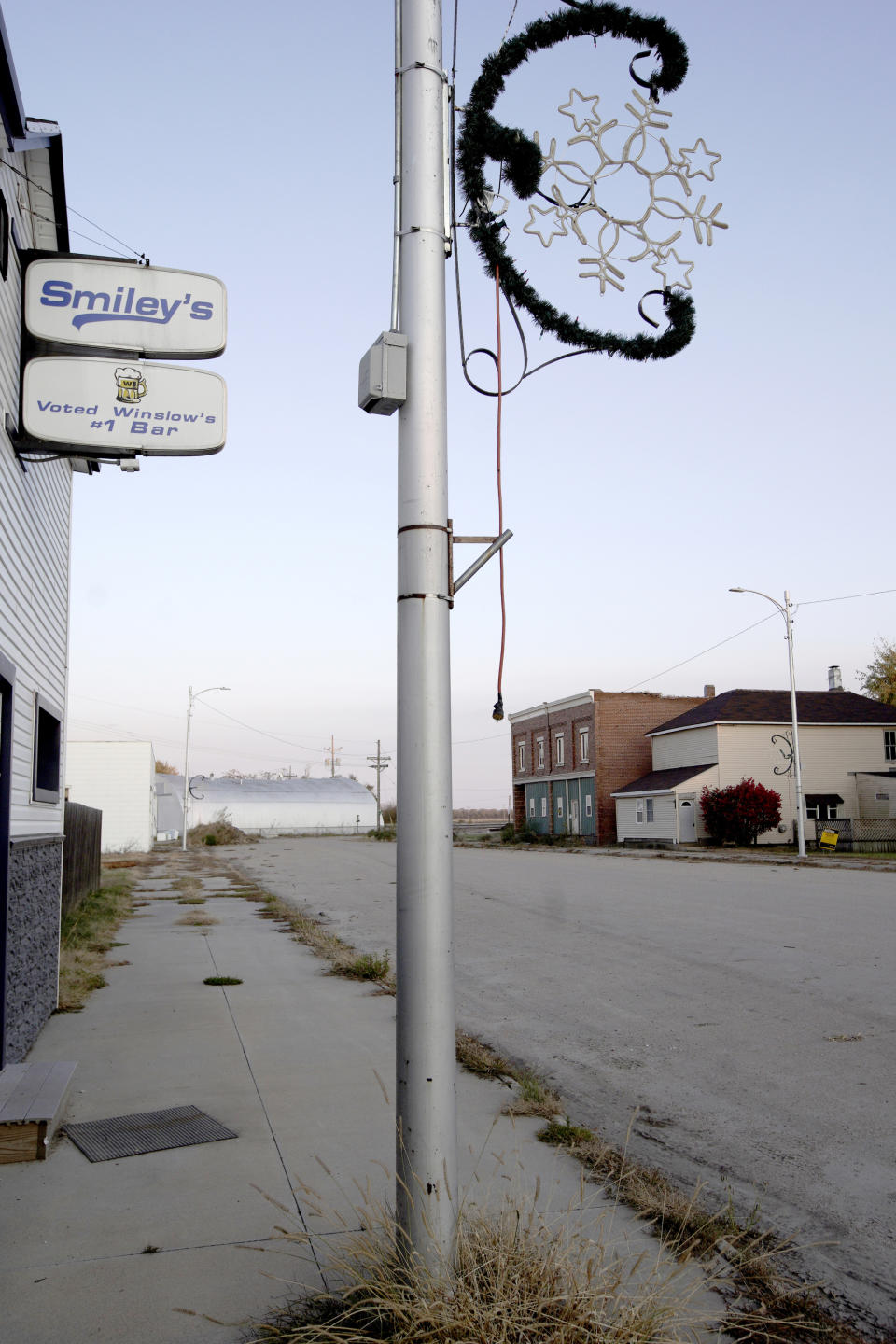 In this Oct. 24, 2019 photo, a sign at Smiley's Bar proclaims it to be Winslow's #1 bar, in Winslow, Neb. It took only minutes for swift-moving floods from the Elkhorn River to ravage tiny Winslow this spring, leaving nearly all its 48 homes and businesses uninhabitable. Now, the couple dozen residents still determined to call the place home are facing a new challenge: Moving the entire town about three miles away to higher ground. (AP Photo/Nati Harnik)