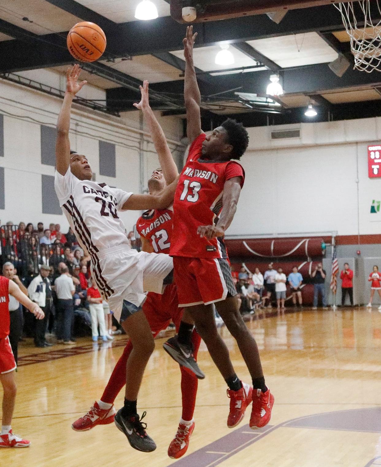 Benedictine's Caleb Jones goes up for a basket against Madison County's Kyle Pruitt and Jay Carruth during the Class 4A quarterfinals on Wednesday March 1, 2023.