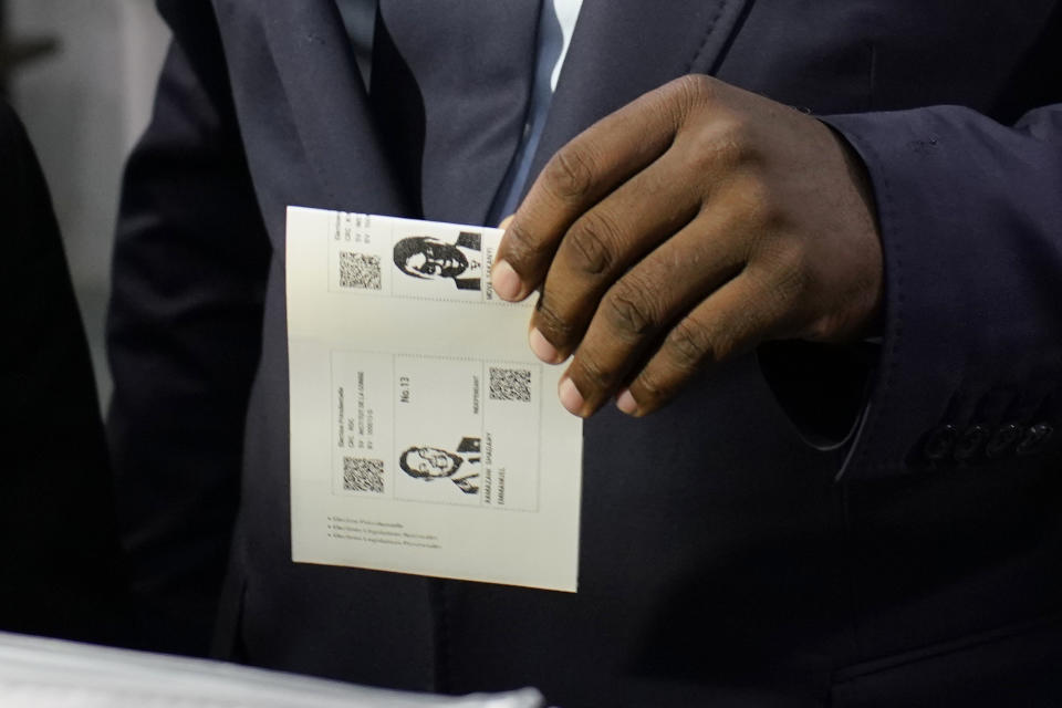 Congolese President Joseph Kabila casts his vote for Emmanuel Ramazani Shadary Sunday, Dec. 30, 2018 in Kinshasa, Congo. Forty million voters are registered for a presidential race plagued by years of delay and persistent rumors of lack of preparation. (AP Photo/Jerome Delay)