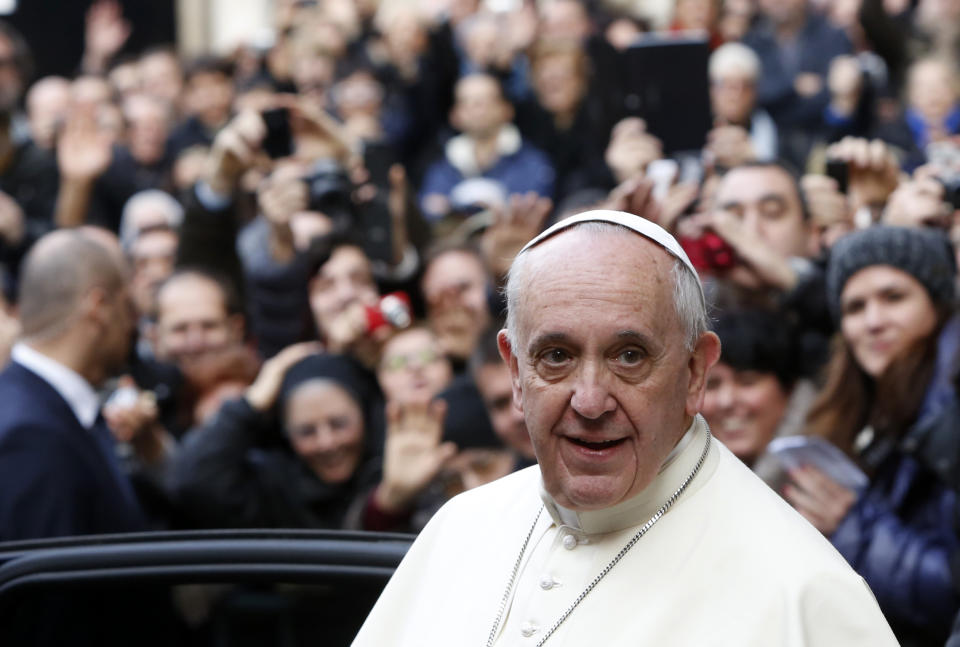 Pope Francis leaves Rome's Jesus' Church after celebrating a mass with the Jesuits, on the occasion of the order's titular feast, Friday, Jan. 3, 2014. (AP Photo/Riccardo De Luca)