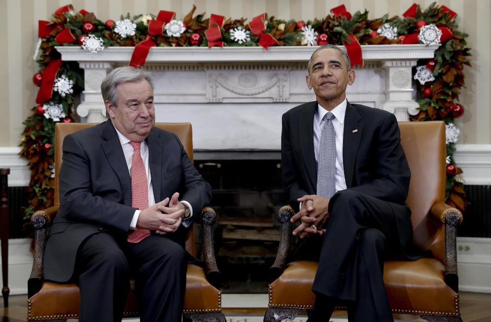 FILE - In this Dec. 2, 2016 file photo, President Barack Obama pauses for media to take their places as he meets with United Nations Secretary-General-designate, Antonio Guterres, in the Oval Office of the White House, in Washington. Guterres takes the reins of the United Nations on New Year's Day, promising to be a "bridge-builder" but facing an antagonistic incoming U.S. administration led by Donald Trump who thinks the world body's 193 member states do nothing except talk and have a good time. (AP Photo/Carolyn Kaster, File)