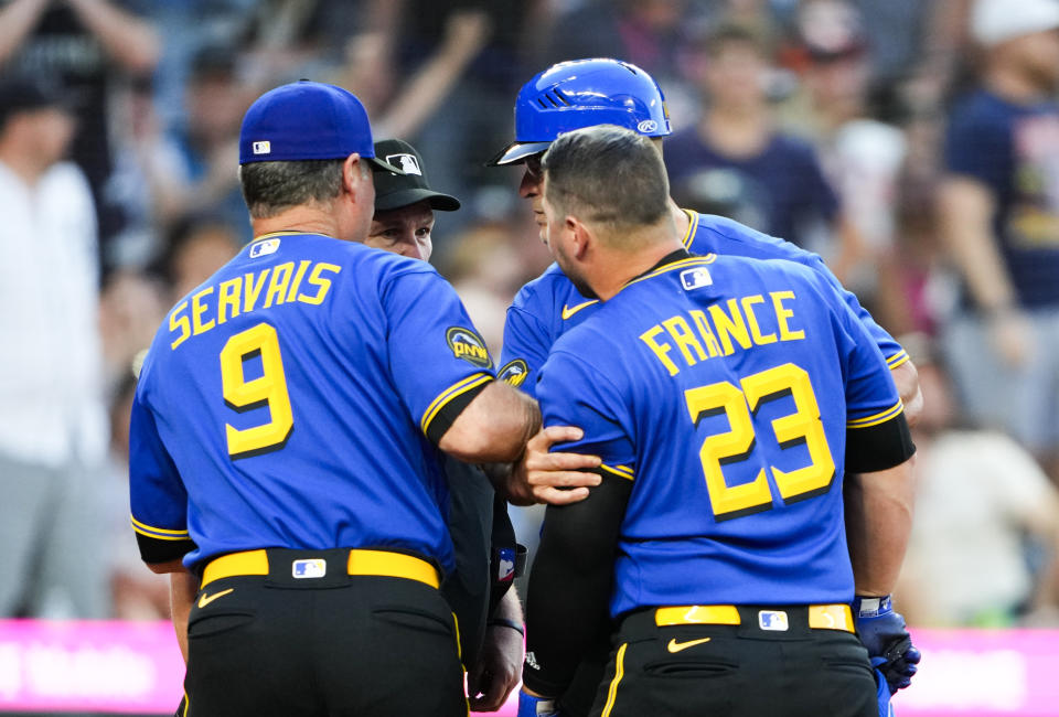 Seattle Mariners' Ty France (23) remonstrates with home plate umpire Marvin Hudson after being ejected during the fifth inning of the team's baseball game against the Detroit Tigers on Friday, July 14, 2023, in Seattle. Holding back France are manager Scott Servais (9) and third base coach Manny Acta. (AP Photo/Lindsey Wasson)