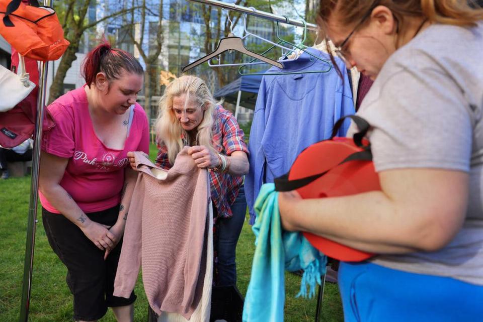 People browse through a selection of free clothing during a rally at the Nakamura Federal Courthouse.