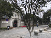 In this photo provided to the Associated Press, a person walks down a lane in Wuhan in central China's Hubei Province, Monday, Jan. 27, 2020. China on Monday expanded sweeping efforts to contain a viral disease by extending the Lunar New Year holiday to keep the public at home and avoid spreading infection. (AP Photo)