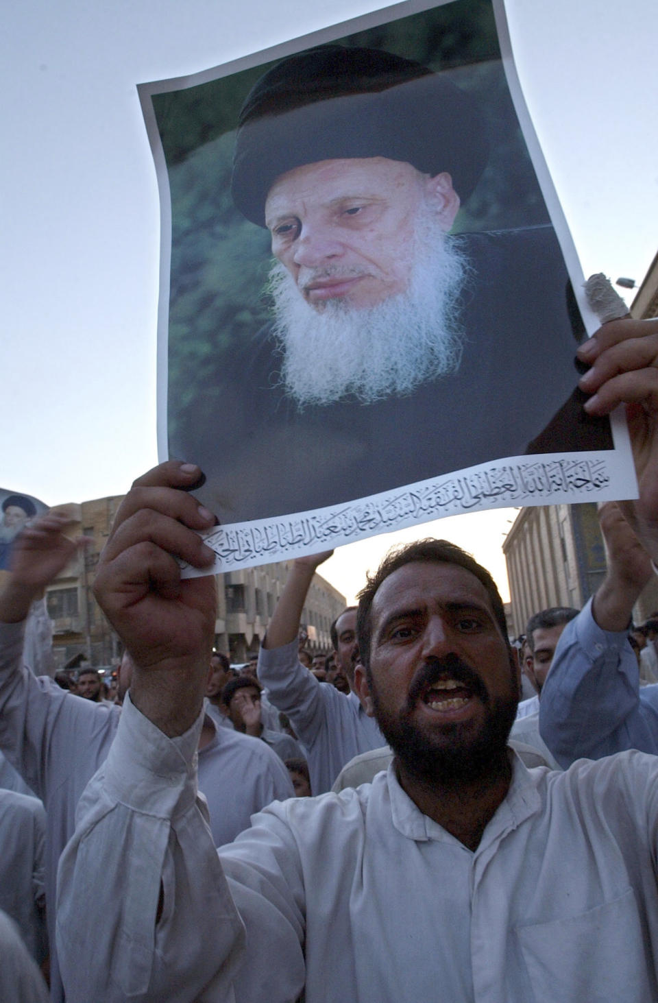 File -In this Sunday, Aug. 24, 2003 file photo, Iraqi Shiites protest an attack on Mohammed Saeed al-Hakim, one of Iraq's most influential Muslim Shiite clerics, in the holy city of Najaf. l-Hakim, one of Iraq's most senior and influential Muslim Shiite clerics, has died, members of his family said. He was 85. (AP Photo/Samir Mezban, File)