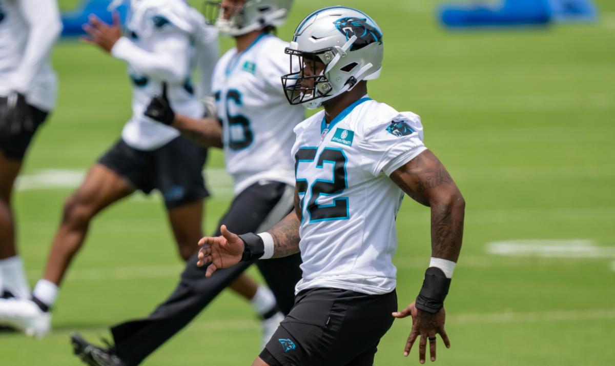 Chandler Wooten of the Carolina Panthers tackles Jeremy Ruckert of