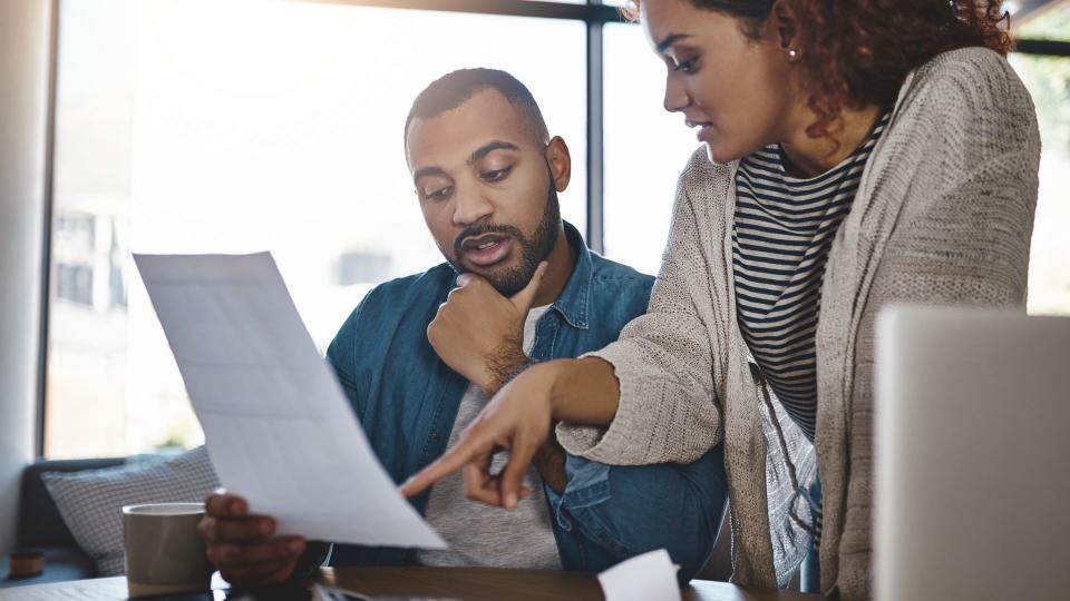 Shot of a young couple planning their budget together at home.