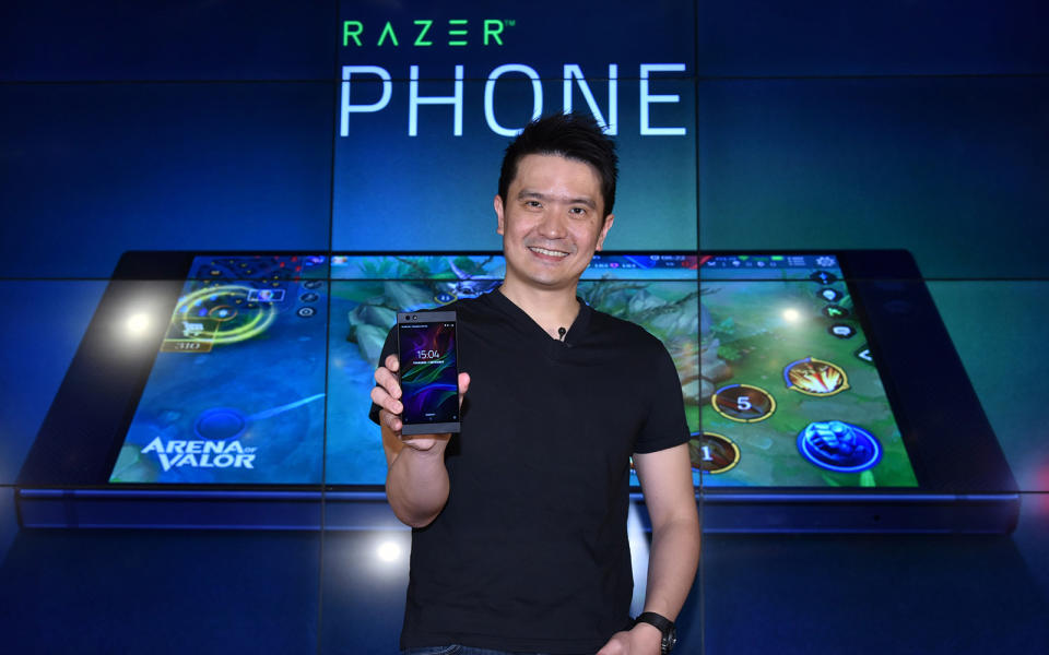Razer CEO Min-Liang Tan holding a Razer Phone.
